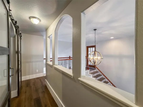 a view of staircase with wooden floor