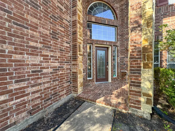 a brick building with a door and a window