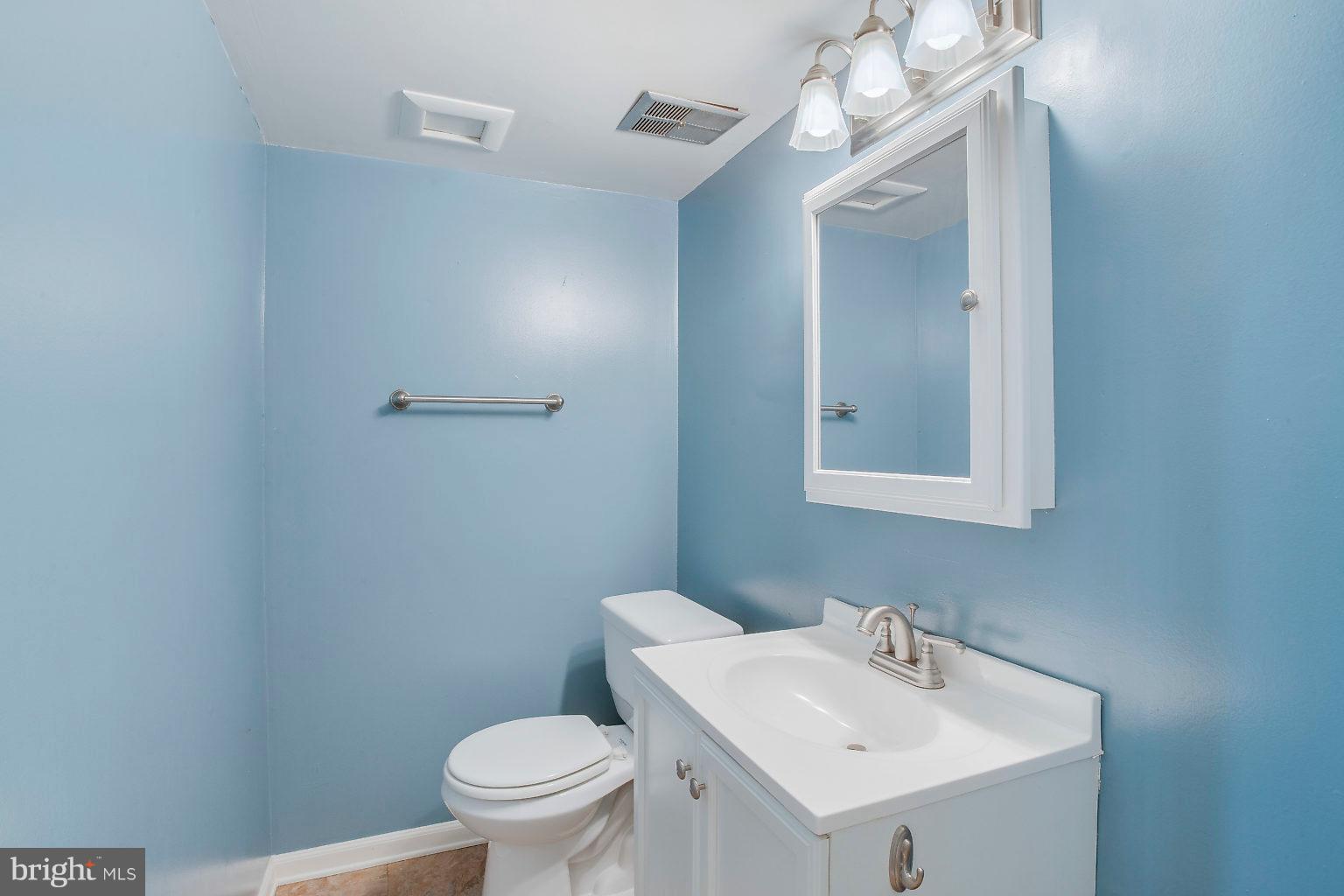 2011 Shore Road Dundalk, MD 21222 - Photo 12 of 37 a bathroom with a sink a toilet and mirror