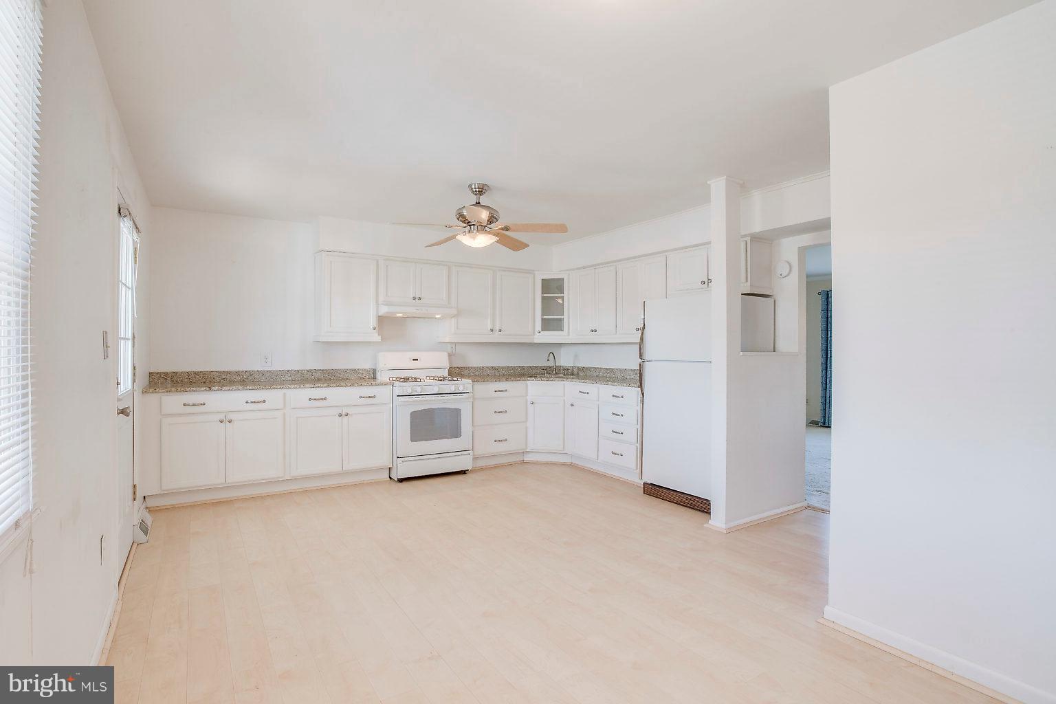 2011 Shore Road Dundalk, MD 21222 - Photo 23 of 37 a kitchen with white cabinets and white appliances
