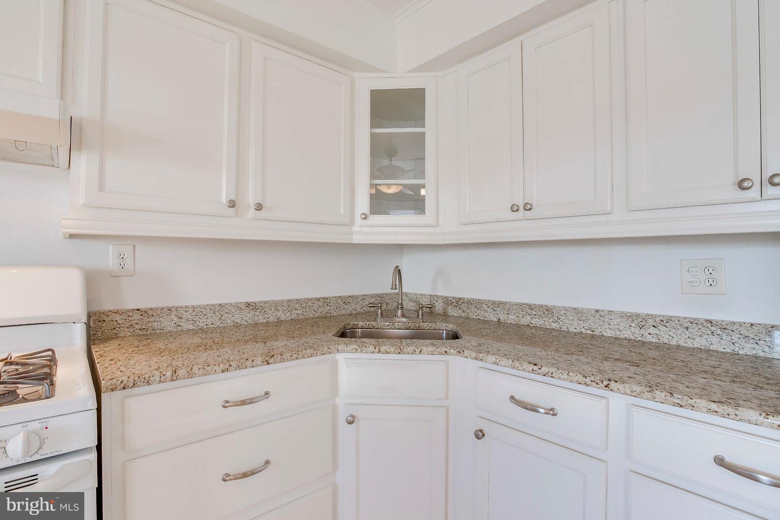 2011 Shore Road Dundalk, MD 21222 - Photo 28 of 37 a kitchen with granite countertop white cabinets and a sink