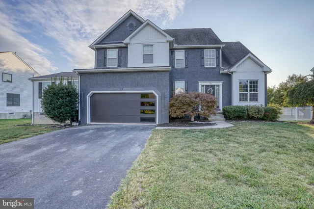 a view of a patio with couches chairs potted plants and wooden floor