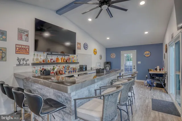 a view of a dining room with furniture large windows and wooden floor
