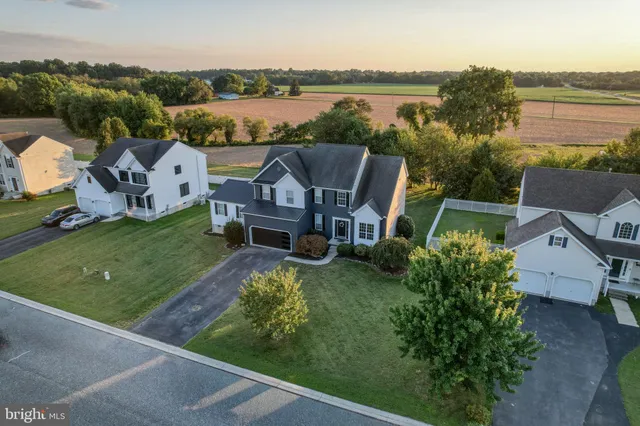 an aerial view of a house with a garden and lake view