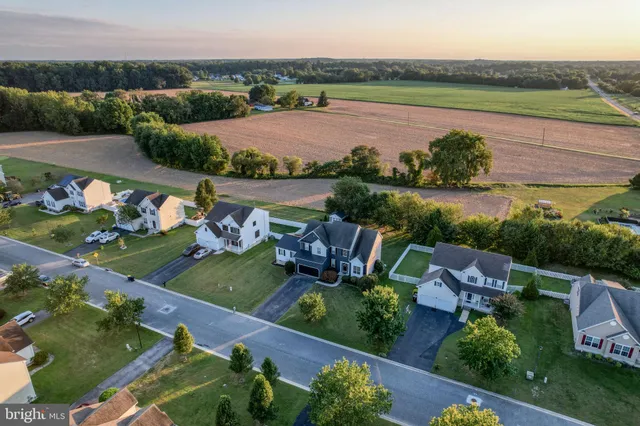 an aerial view of a house with outdoor space and lake view