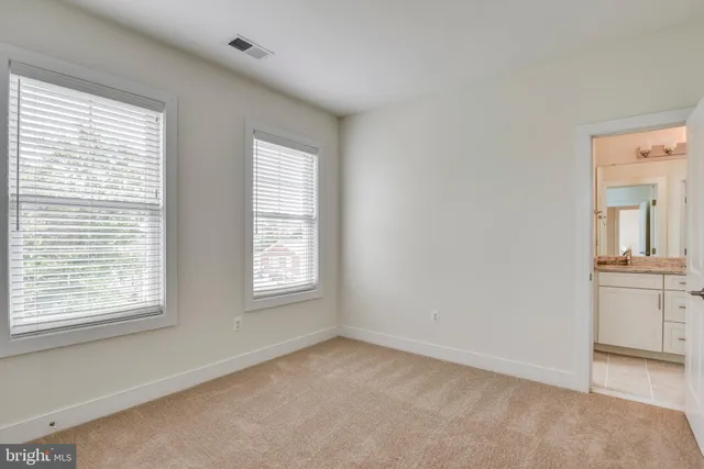 an empty room with a window and wooden floor
