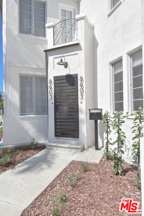 8603 Whitworth Drive Los Angeles, CA 90035 - Photo 1 of 1 a front view of a house with a yard and garage