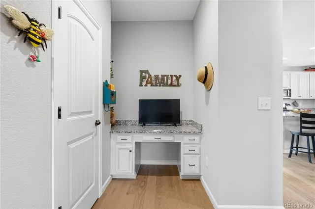 a hallway with a stove and a microwave