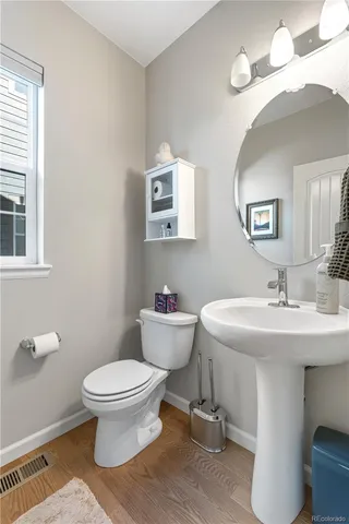 a bathroom with a sink toilet and a mirror
