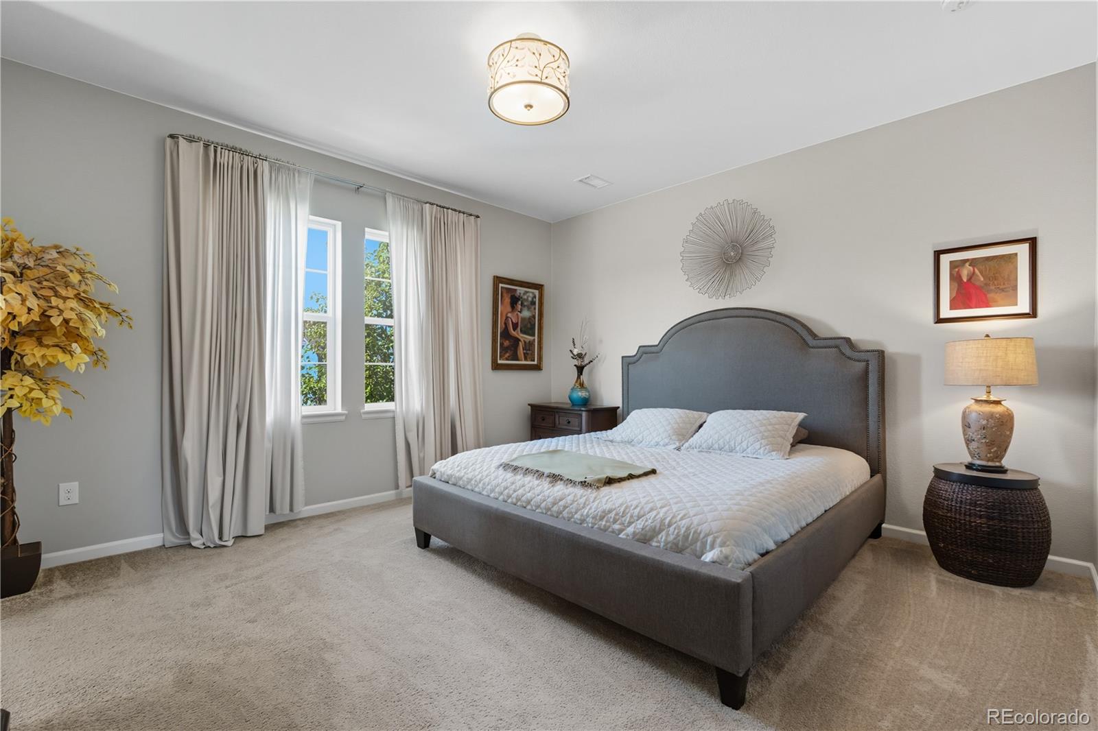10074 Flower Street Broomfield, CO 80021 - Photo 20 of 47 a bedroom with a bed lamp and a window