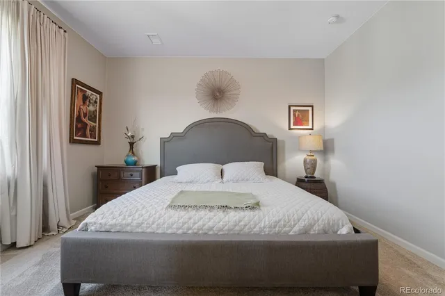 a bedroom with a bed and lamp