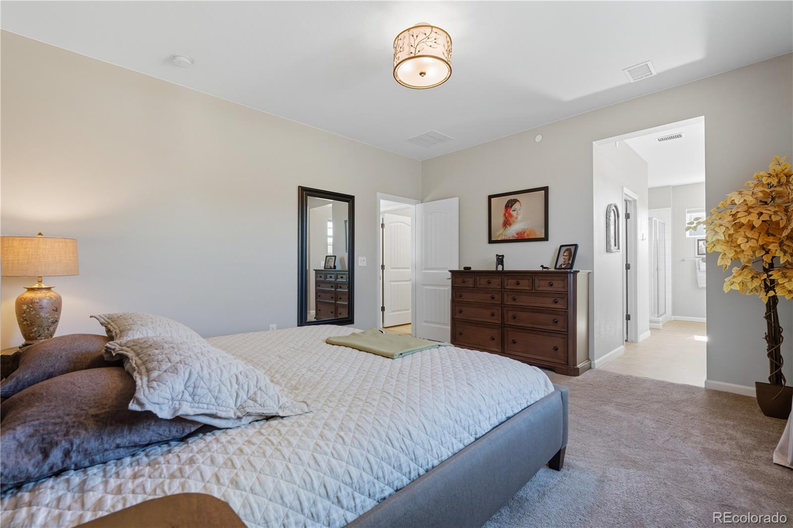 10074 Flower Street Broomfield, CO 80021 - Photo 22 of 47 a bedroom with a bed and a dresser