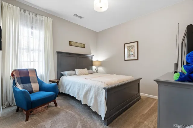 a bedroom with a bed and a couch