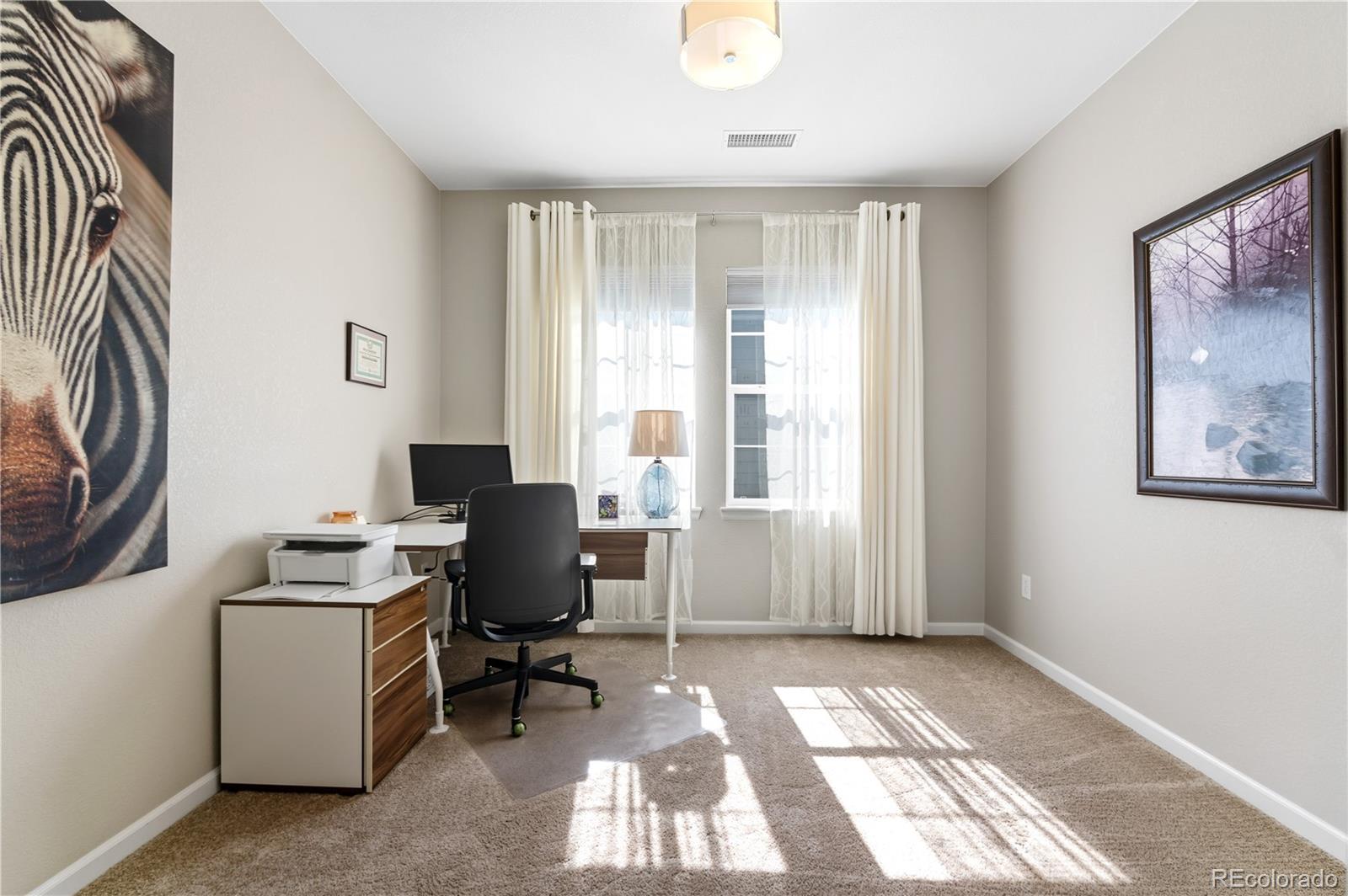10074 Flower Street Broomfield, CO 80021 - Photo 29 of 47 a view of a workspace with furniture and a window