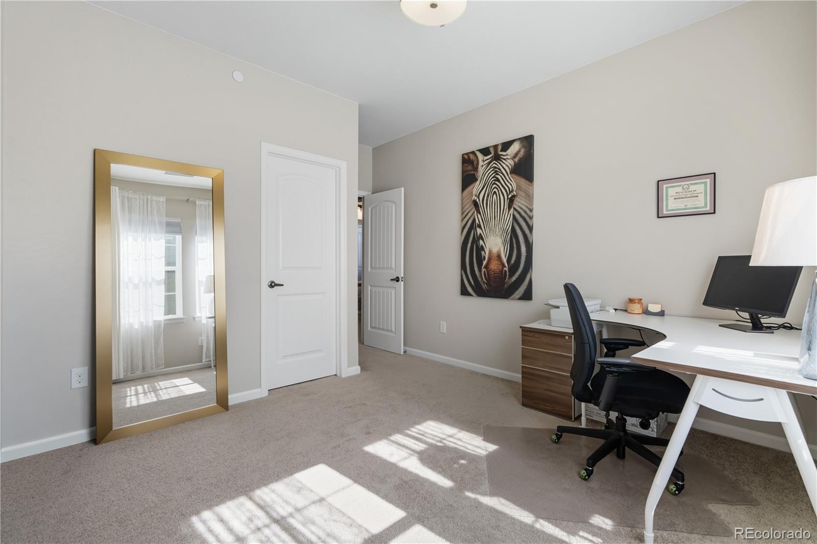 10074 Flower Street Broomfield, CO 80021 - Photo 30 of 47 a view of a workspace with furniture and a window