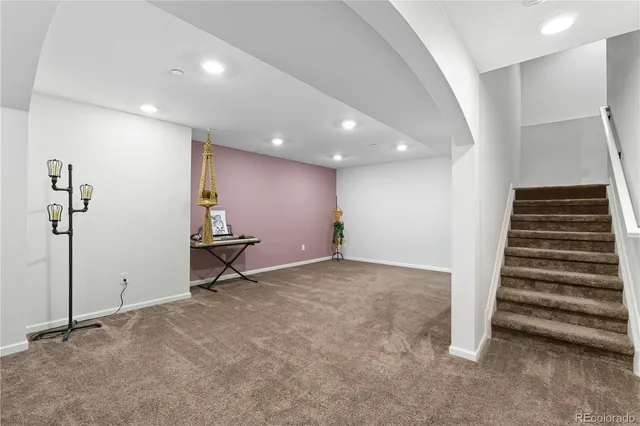 a view of an empty room with stairs and ventilation