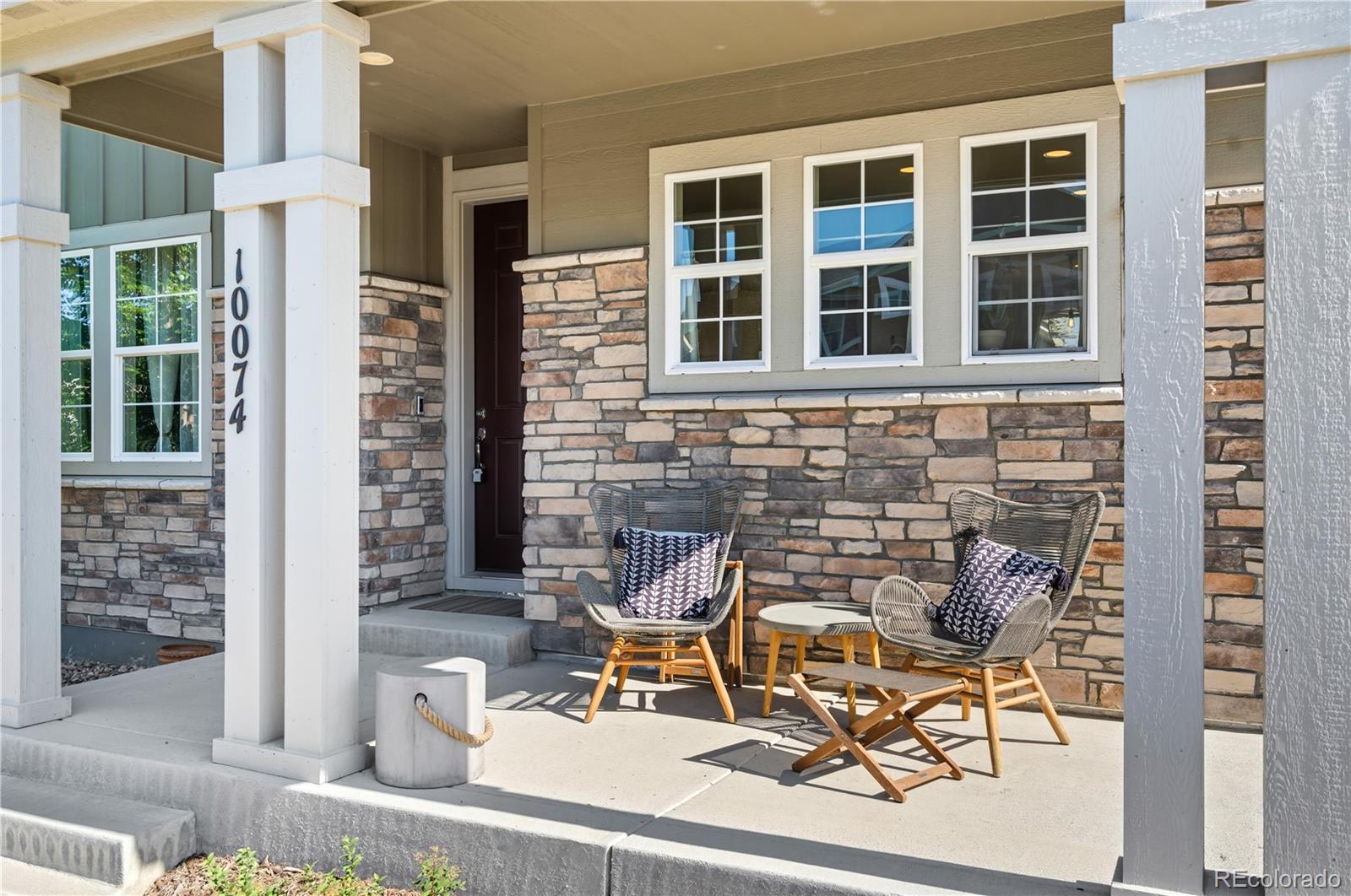 10074 Flower Street Broomfield, CO 80021 - Photo 42 of 47 a view of a patio with table and chairs and potted plants