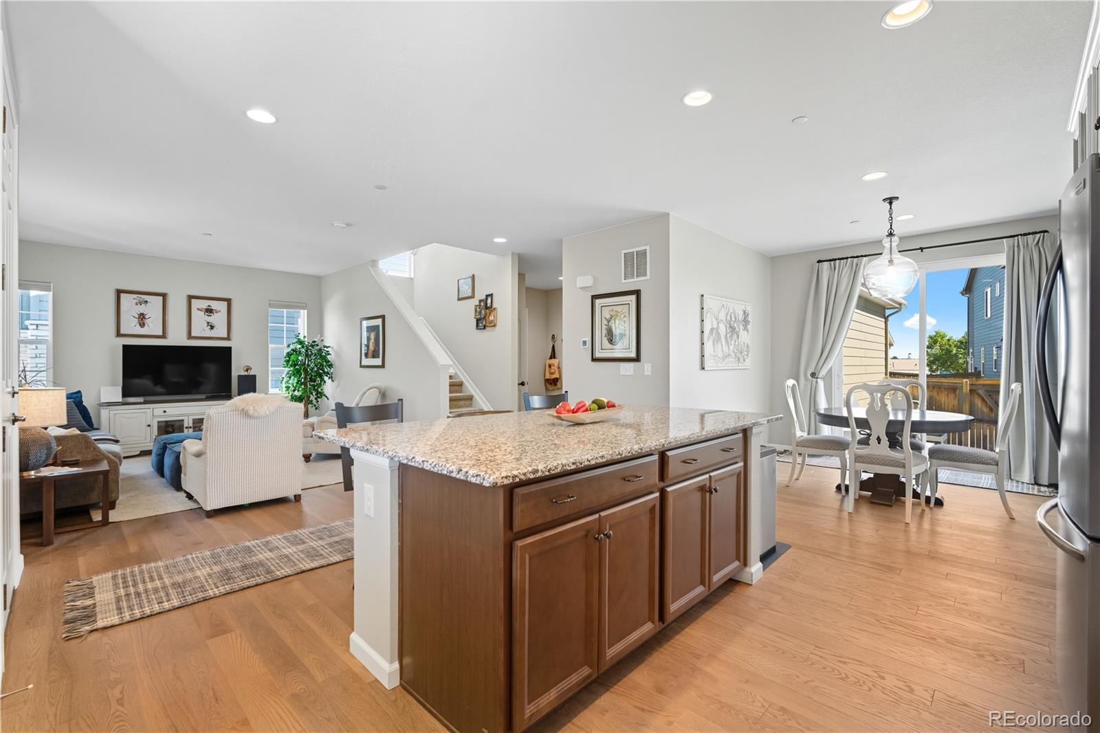 10074 Flower Street Broomfield, CO 80021 - Photo 7 of 47 a living room with granite countertop furniture and a flat screen tv