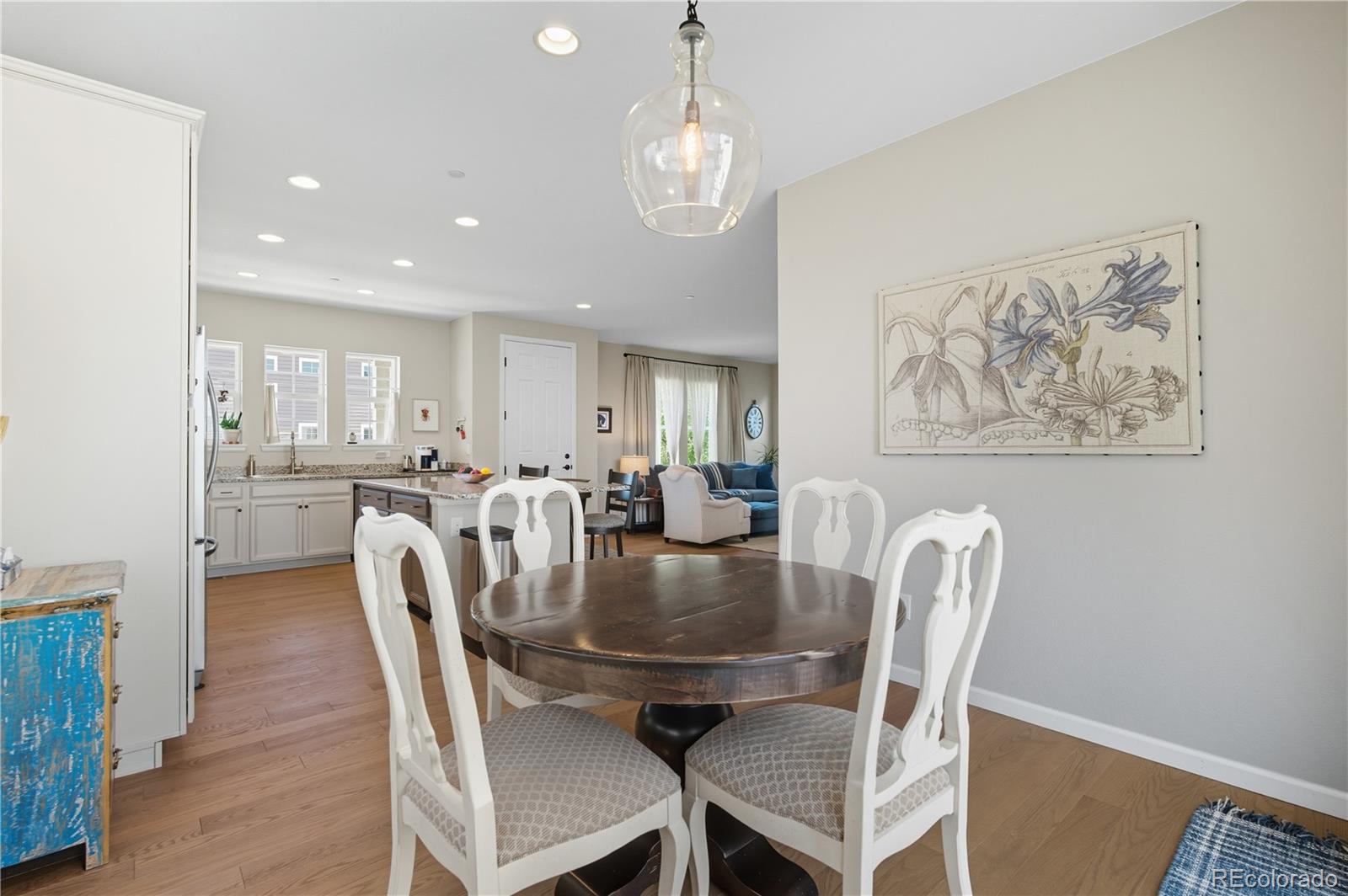10074 Flower Street Broomfield, CO 80021 - Photo 8 of 47 a view of a dining room with furniture and wooden floor
