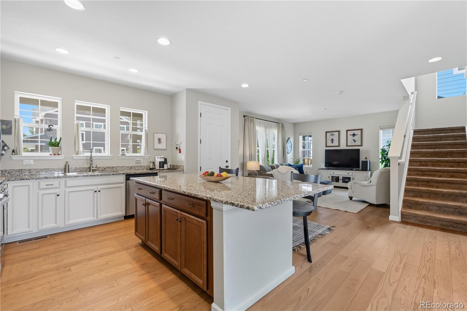 10074 Flower Street Broomfield, CO 80021 - Photo 10 of 47 a kitchen with sink stove and cabinets