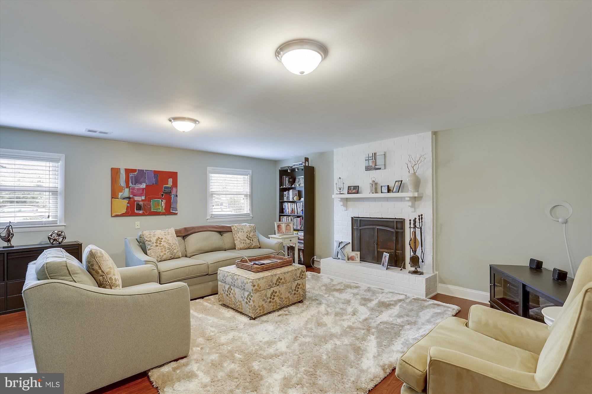 129 Beaumont Road Silver Spring, MD 20904 - Photo 14 of 30 Family room with wood burning fireplace and mantle