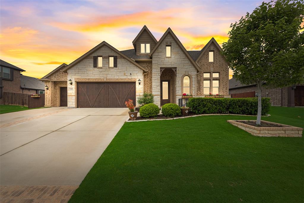 a front view of a house with a garden and plants