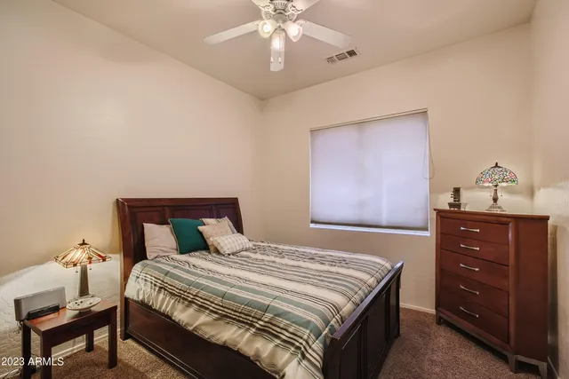 a bed sitting in a bedroom next to a window