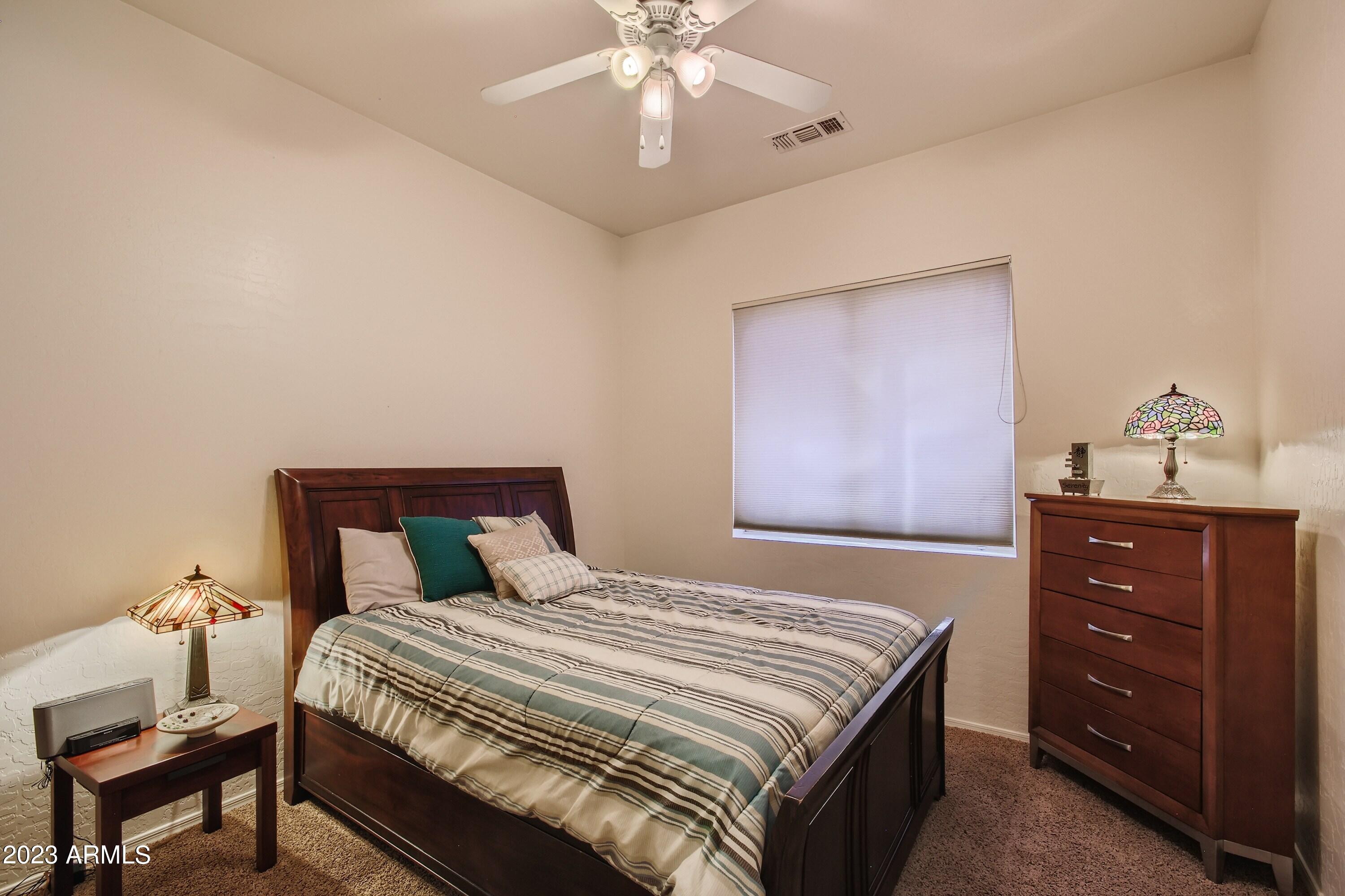 3060 North Ridgecrest, Unit 175 Mesa, AZ 85207 - Photo 21 of 28 a bedroom with a bed and a dresser