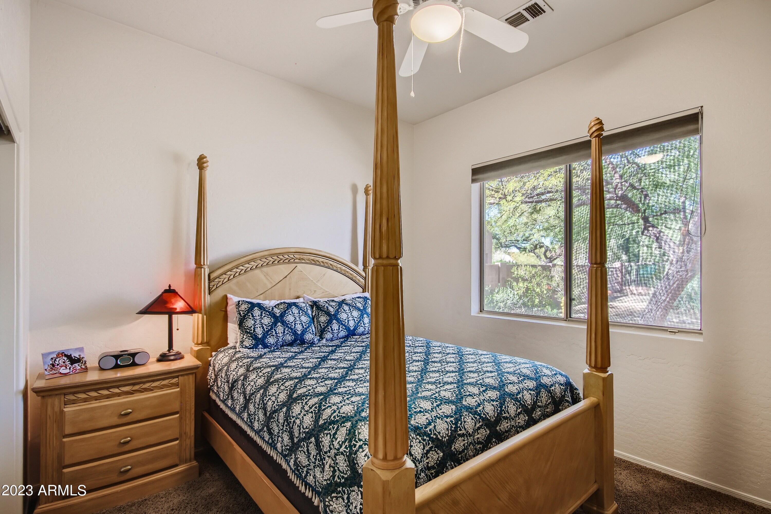 3060 North Ridgecrest, Unit 175 Mesa, AZ 85207 - Photo 22 of 28 a bed sitting in a bedroom next to a window