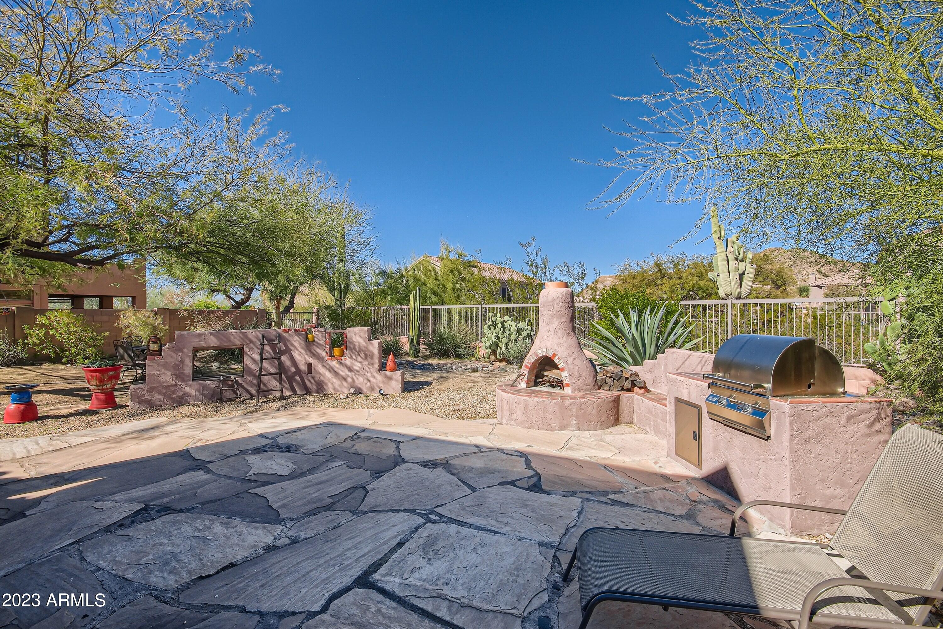 3060 North Ridgecrest, Unit 175 Mesa, AZ 85207 - Photo 27 of 28 a view of a patio with a table and chairs under an umbrella
