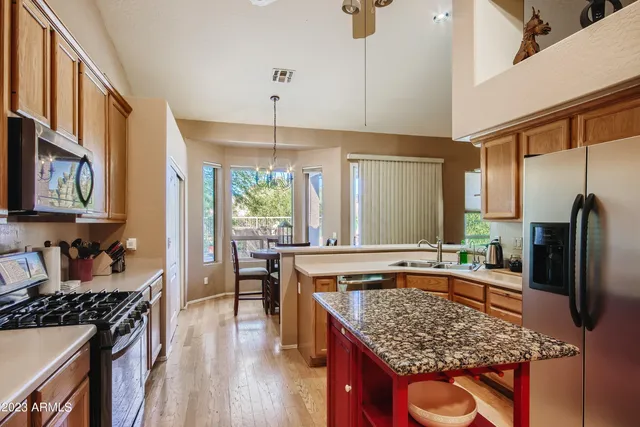 a kitchen with stainless steel appliances granite countertop a stove oven and a refrigerator