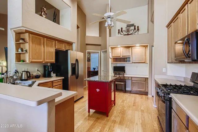 a kitchen with stainless steel appliances granite countertop a refrigerator stove and sink