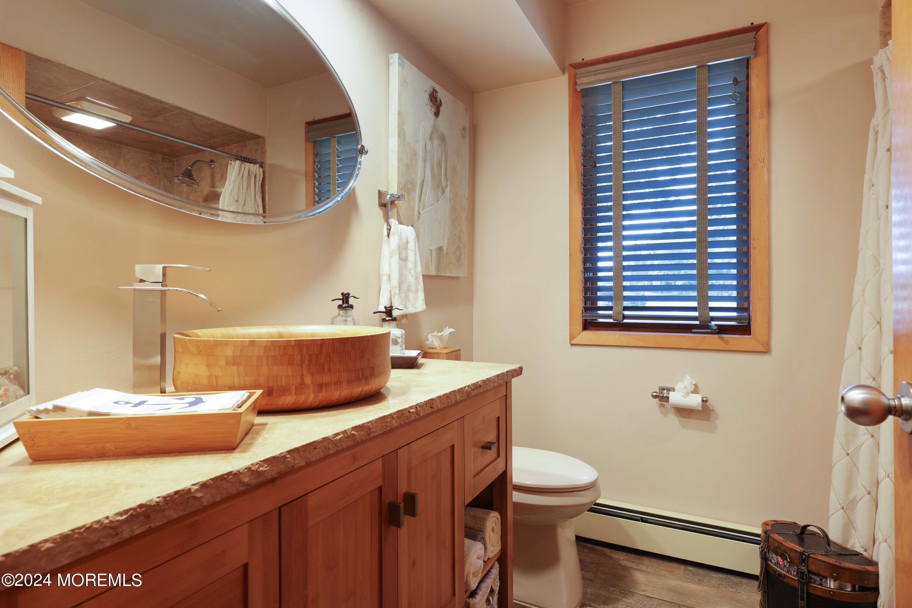 516 Matawan Avenue Keyport, NJ 07735 - Photo 23 of 59 a bathroom with a granite countertop sink and a mirror