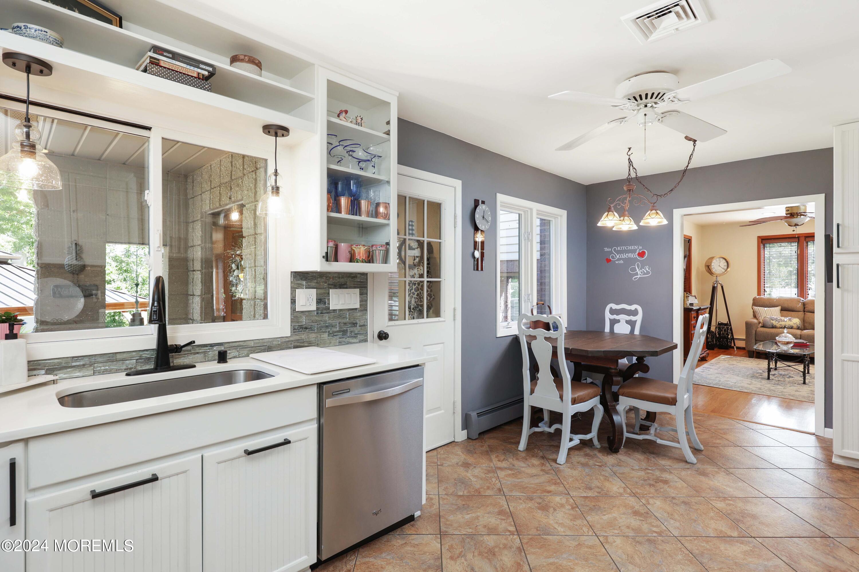 516 Matawan Avenue Keyport, NJ 07735 - Photo 26 of 59 a kitchen with a dining table chairs cabinets and stainless steel appliances
