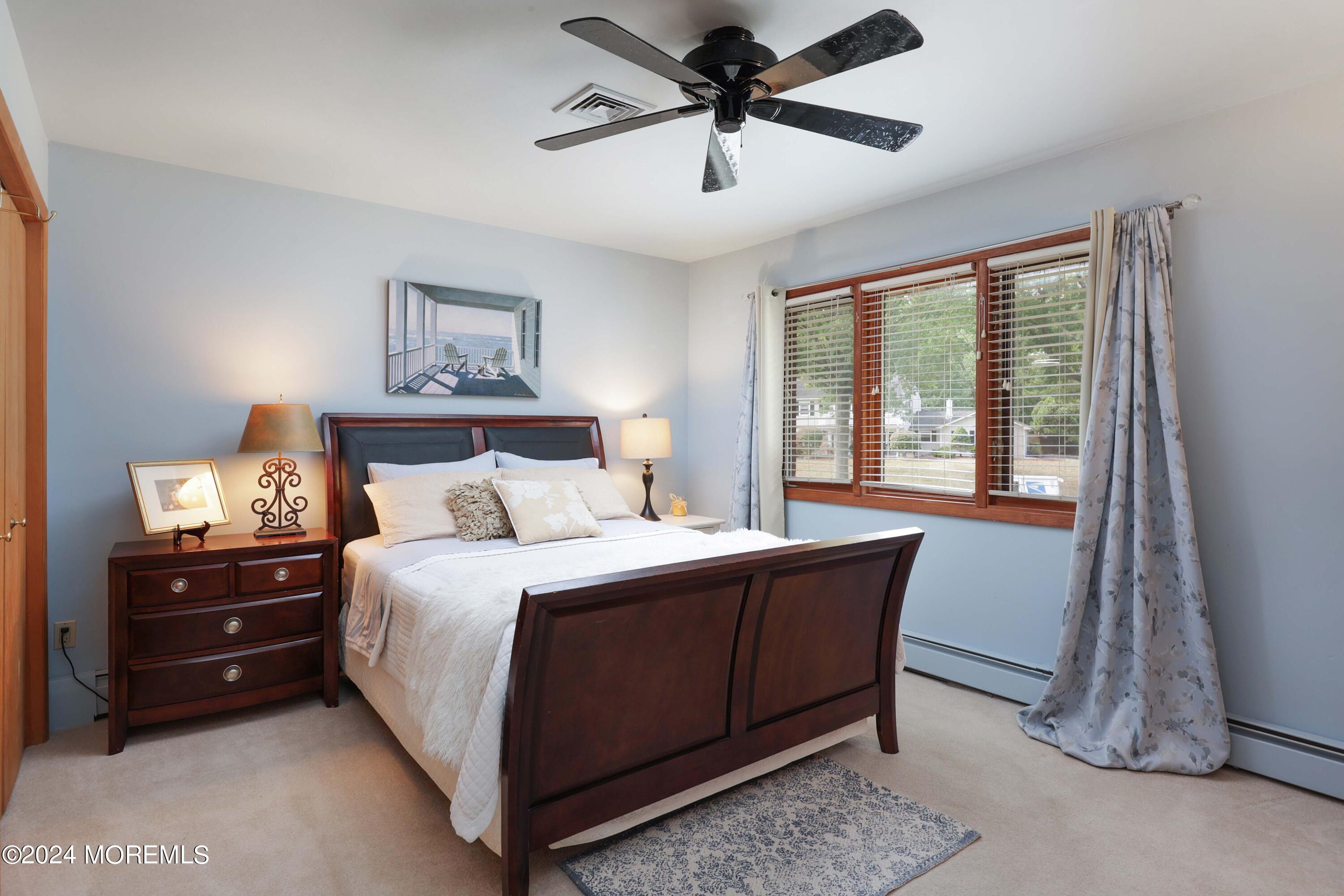 516 Matawan Avenue Keyport, NJ 07735 - Photo 31 of 59 a bedroom with a bed and a chandelier