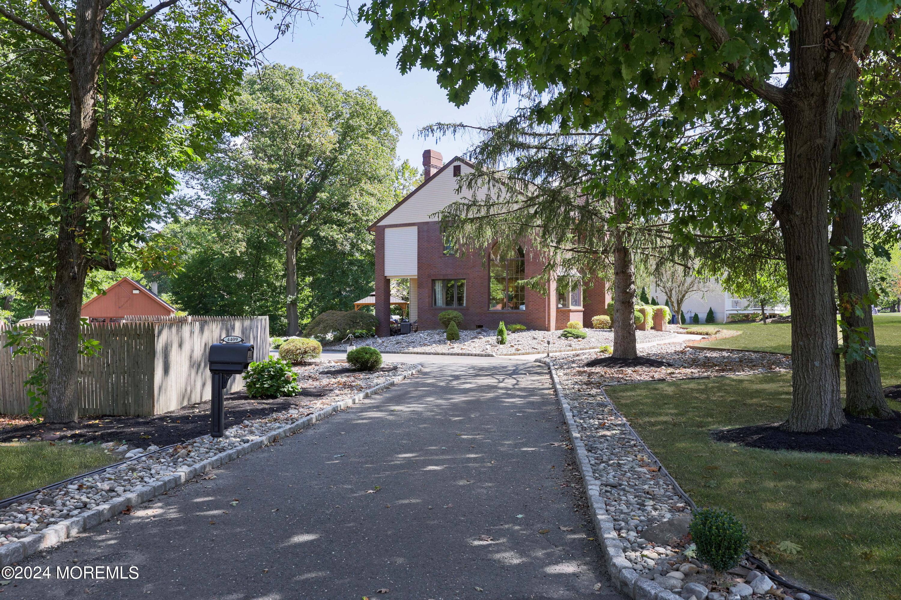 516 Matawan Avenue Keyport, NJ 07735 - Photo 4 of 59 a view of a yard with plants and a large tree