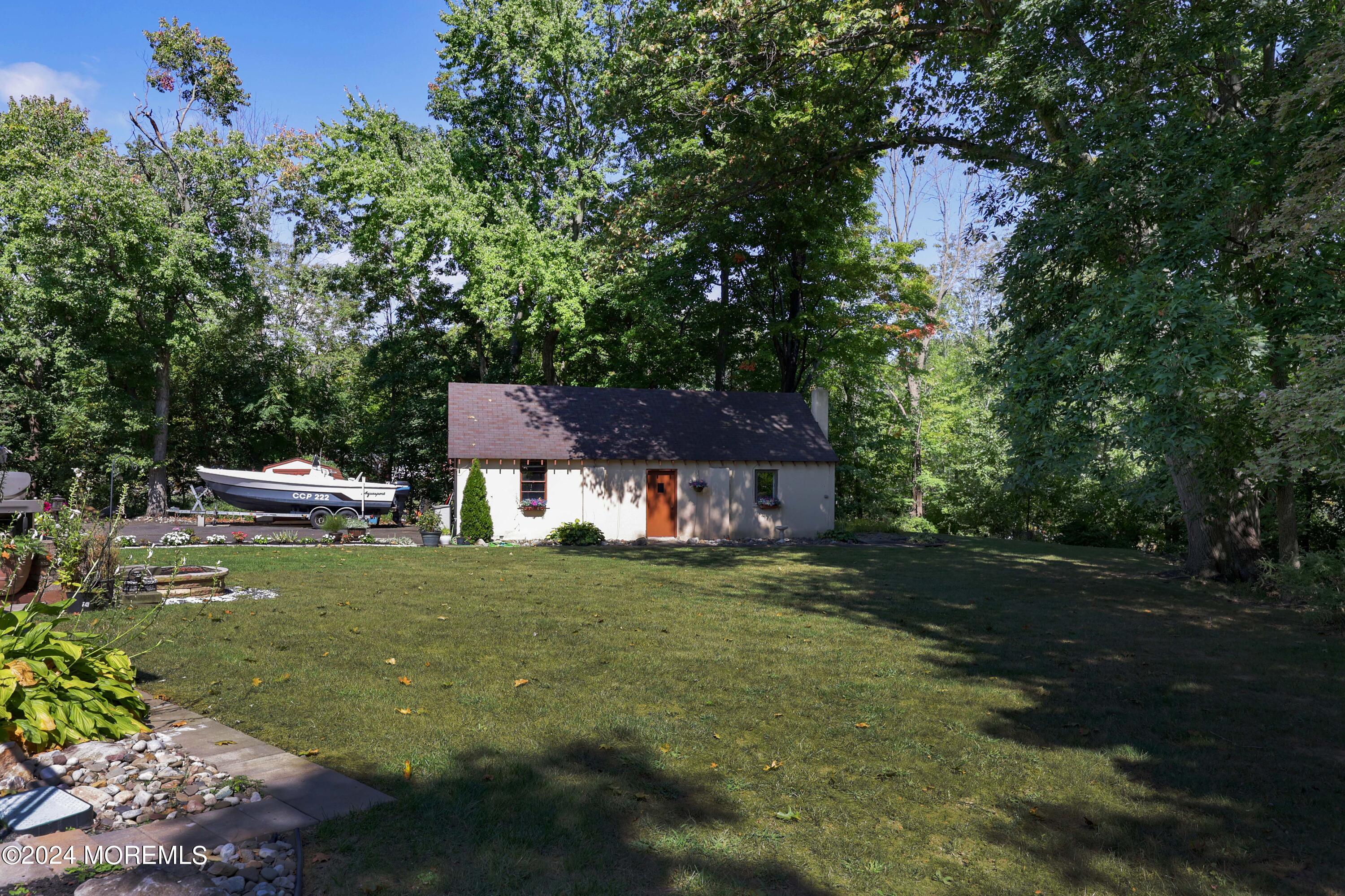 516 Matawan Avenue Keyport, NJ 07735 - Photo 44 of 59 a backyard of a house with a garden and tree