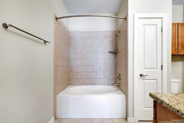 a bathroom with a tub and shower