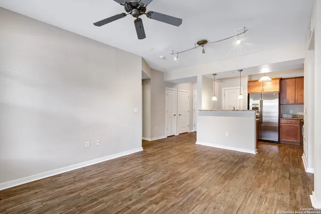 a view of a kitchen with a dishwasher and wooden floor