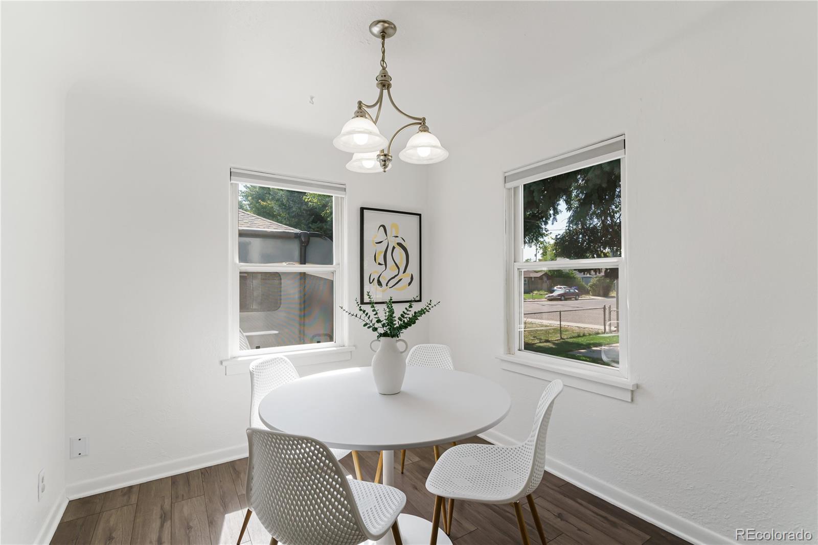 3880 Reed Street Wheat Ridge, CO 80033 - Photo 11 of 40 a view of a dining room with furniture wooden floor and a chandelier