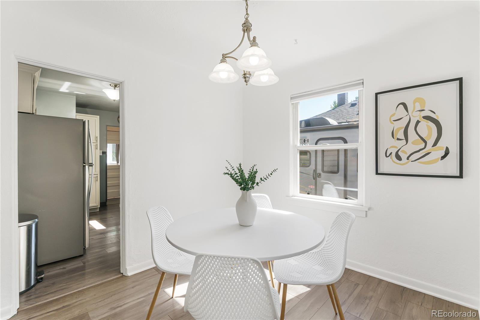 3880 Reed Street Wheat Ridge, CO 80033 - Photo 12 of 40 a view of a dining room with furniture and wooden floor