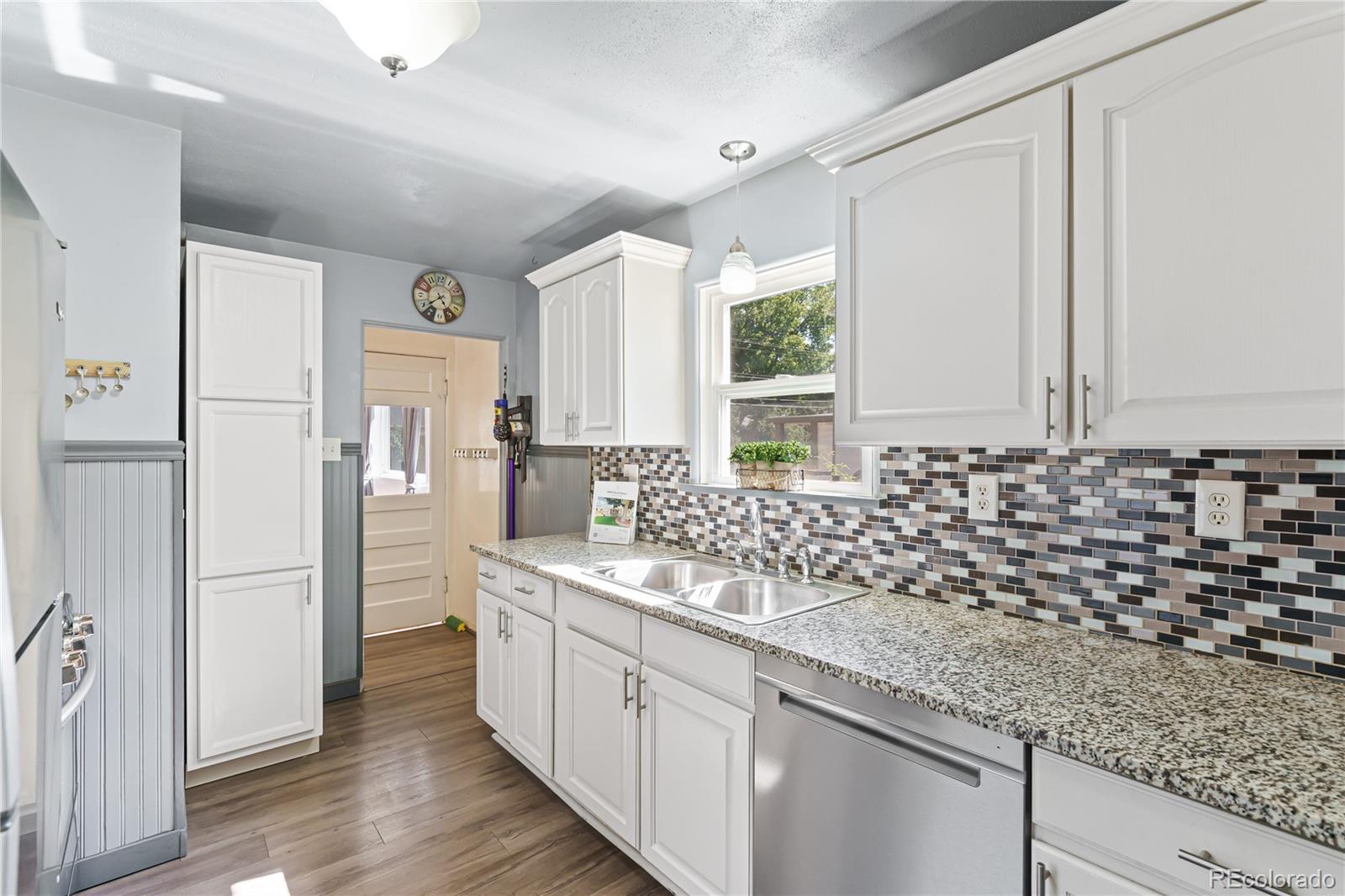 3880 Reed Street Wheat Ridge, CO 80033 - Photo 14 of 40 a bathroom with a sink and a mirror