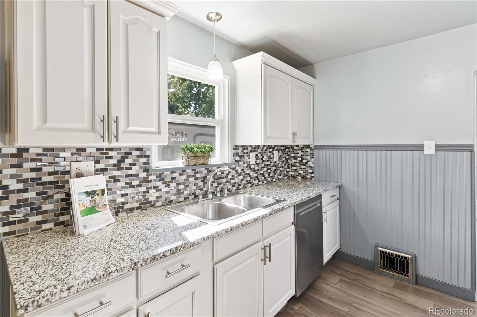 3880 Reed Street Wheat Ridge, CO 80033 - Photo 18 of 40 a kitchen with a sink and cabinets