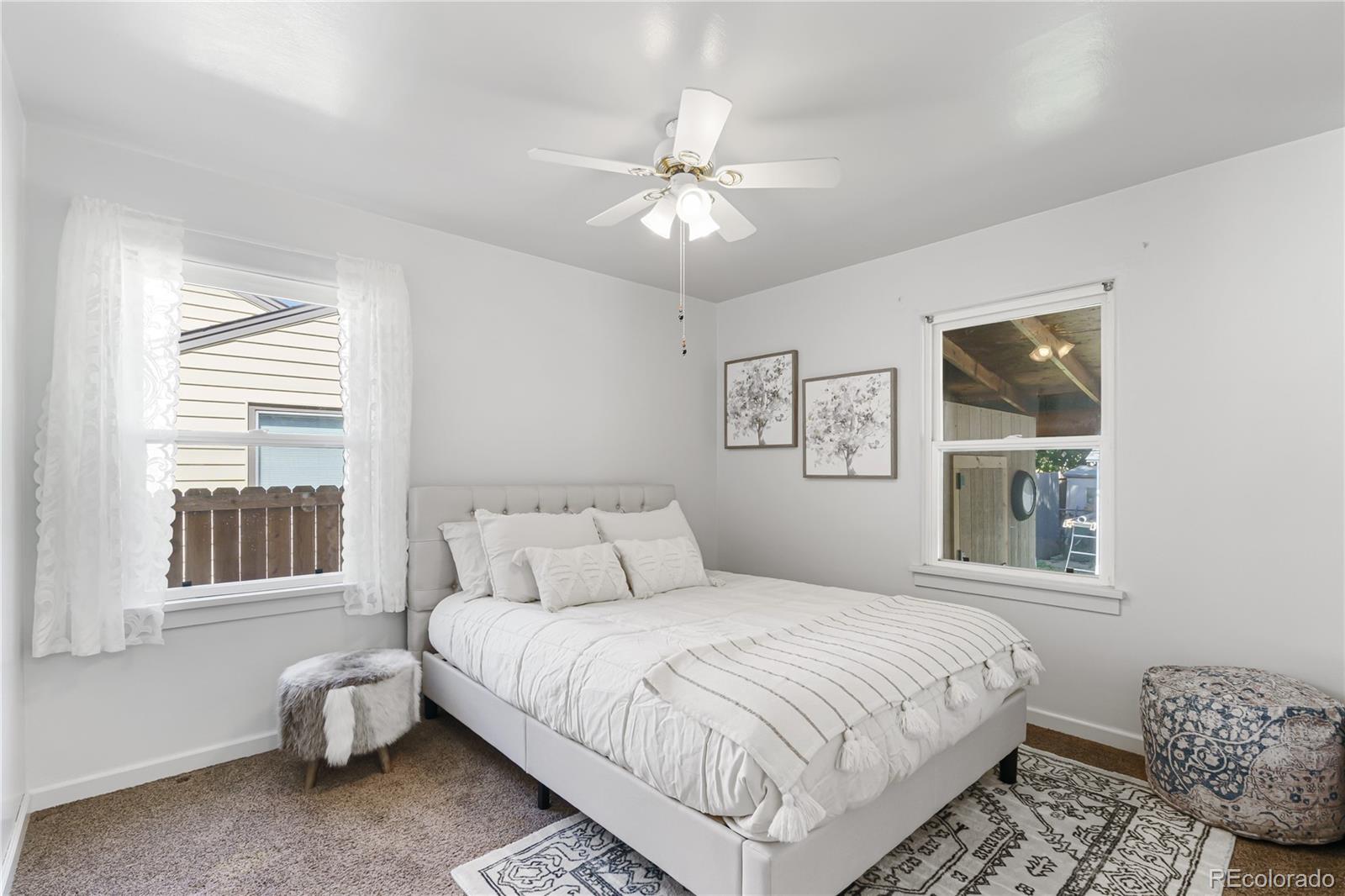 3880 Reed Street Wheat Ridge, CO 80033 - Photo 19 of 40 a bedroom with a large bed and a window