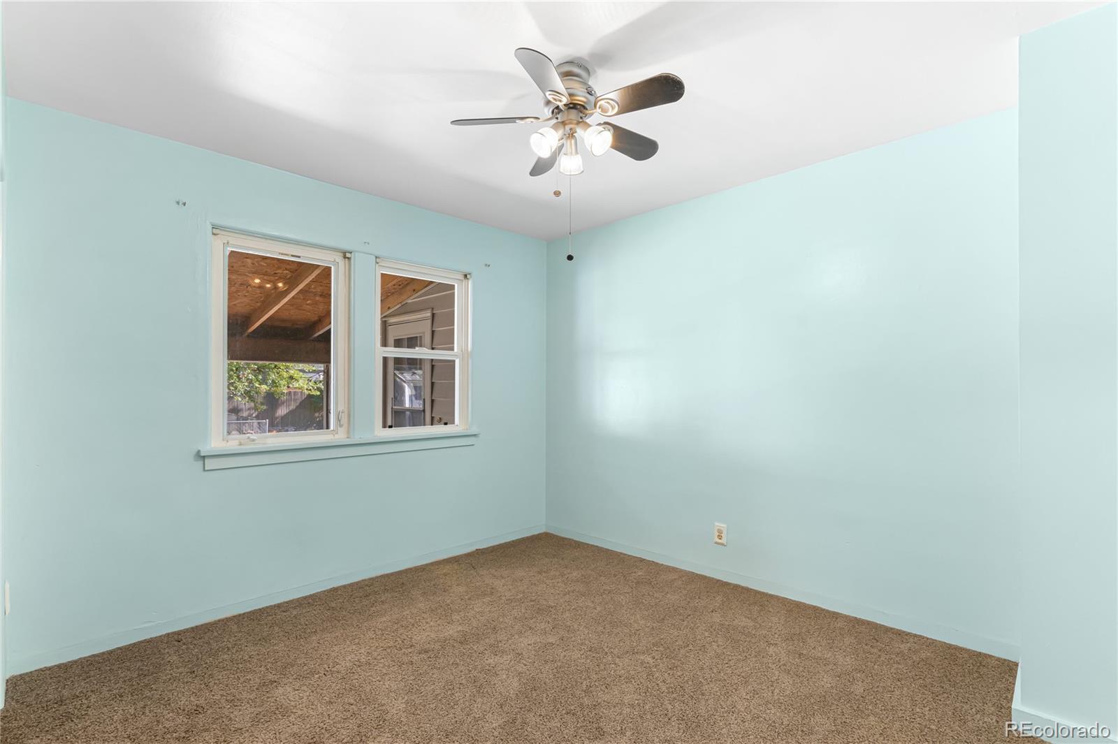 3880 Reed Street Wheat Ridge, CO 80033 - Photo 22 of 40 an empty room with a window and a ceiling fan