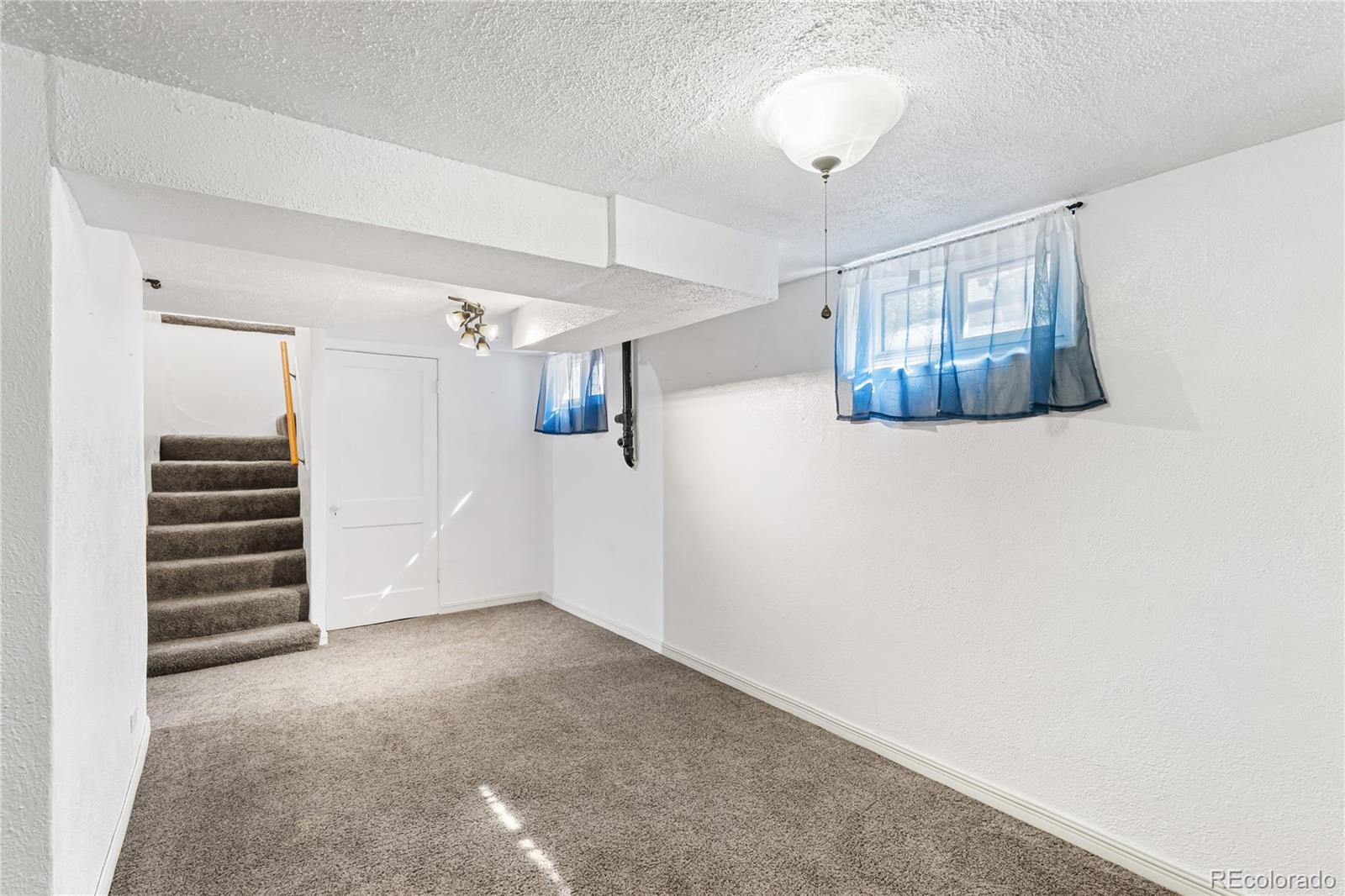 3880 Reed Street Wheat Ridge, CO 80033 - Photo 27 of 40 a view of an empty room with a window