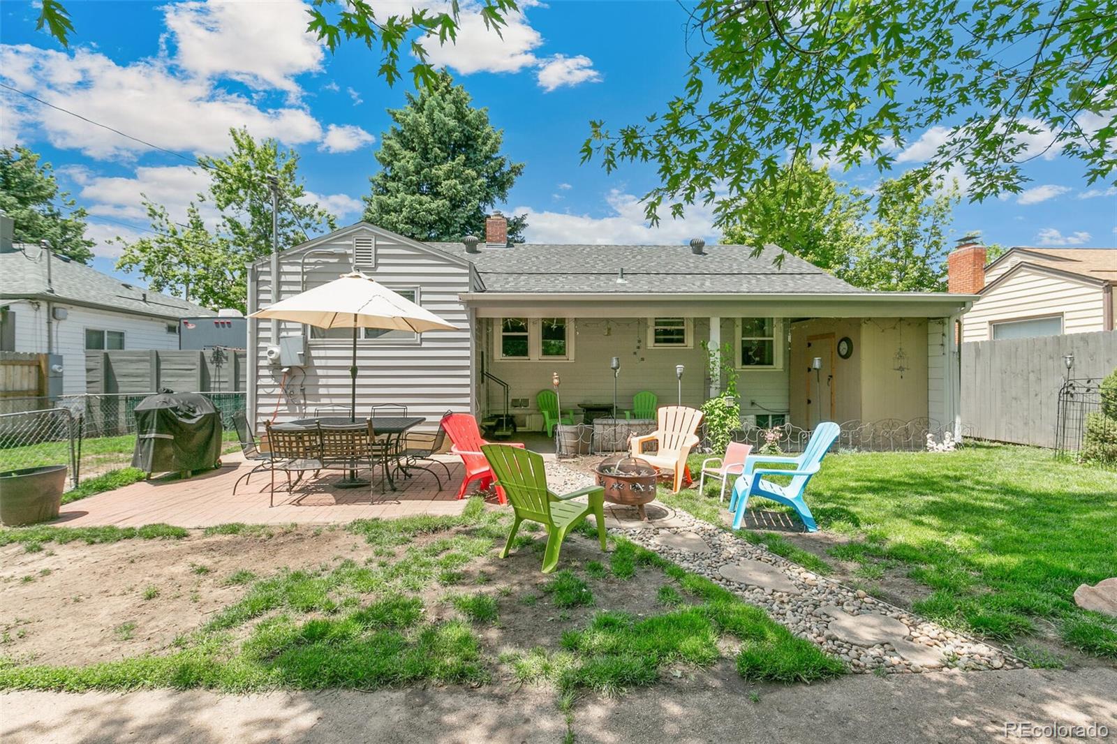 3880 Reed Street Wheat Ridge, CO 80033 - Photo 32 of 40 a view of a house with backyard sitting area and garden