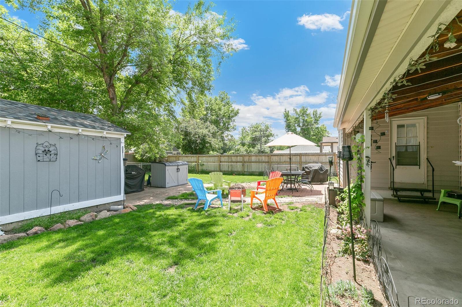 3880 Reed Street Wheat Ridge, CO 80033 - Photo 33 of 40 a view of a chair and table in backyard of the house