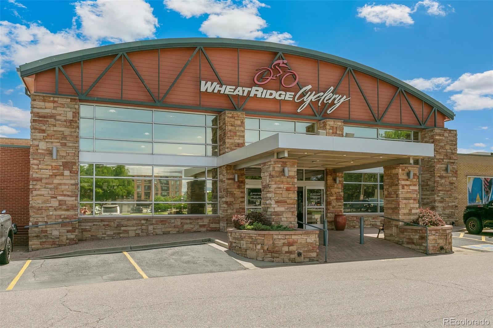 3880 Reed Street Wheat Ridge, CO 80033 - Photo 37 of 40 a front view of a building with glass windows and a garage