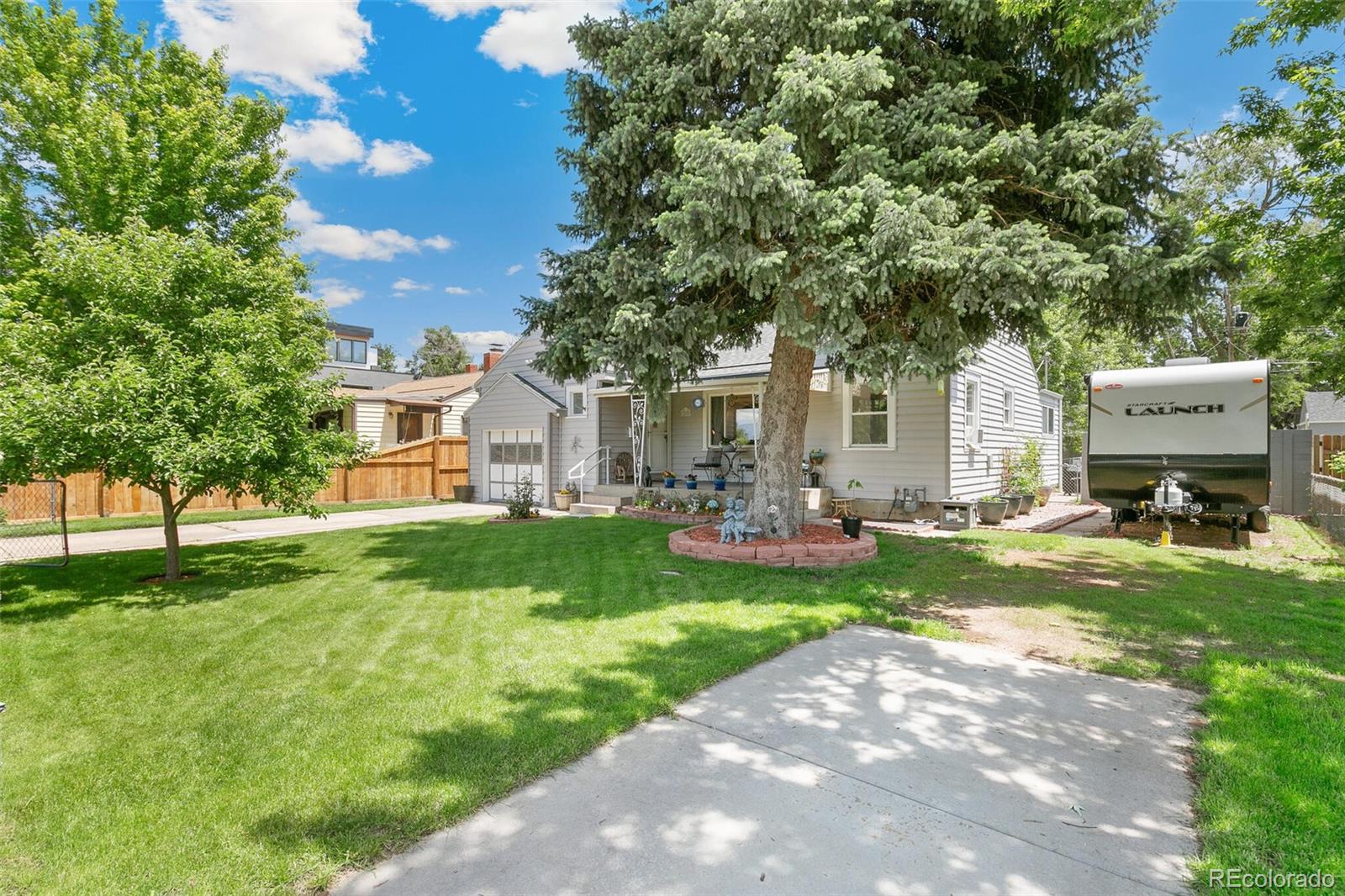 3880 Reed Street Wheat Ridge, CO 80033 - Photo 4 of 40 a front view of a house with garden